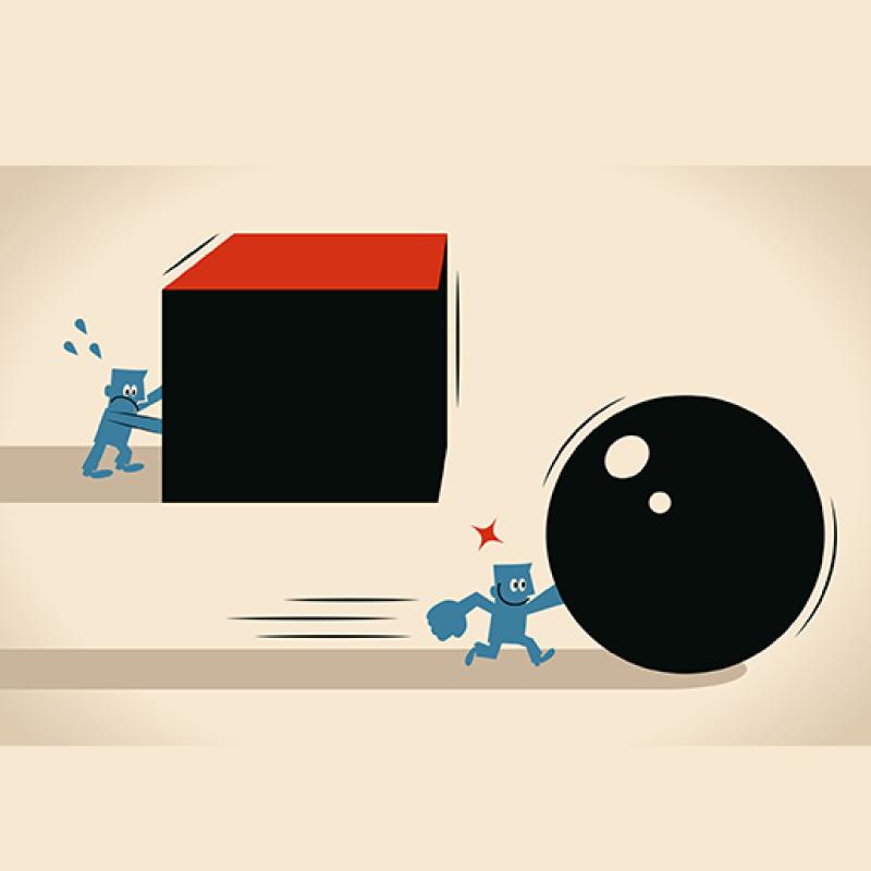 Cartoon person struggling to push a large cube and another easily pushing a large ball
