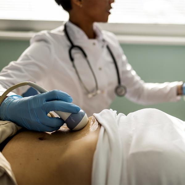 Doctor giving a woman a liver ultrasound